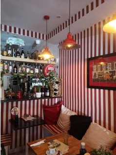 Inside T 42, red and white striped bistro with a cosy bar